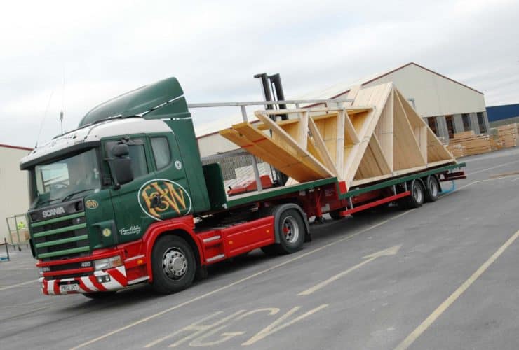roof trusses loaded onto a green lorry