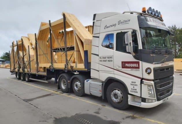 Pasquill delivery van transporting several sizes of roof truss