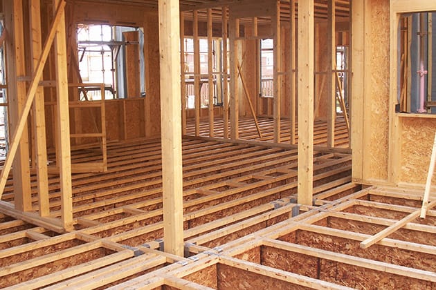 inside of a house under construction with the joists visible