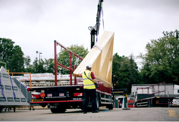 a lorry offloading roof trusses